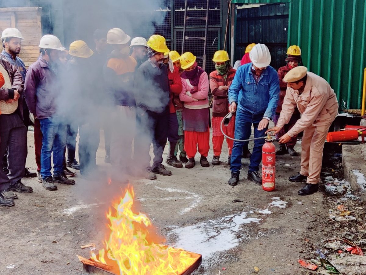 Live fire extinguisher demonstration during safety training